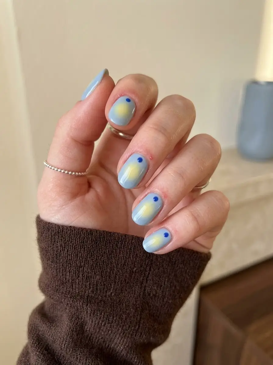 Baby Blue Aura Nails With Yellow Glow - Baby blue base with a pale buttery yellow aura center and subtle cobalt dot accents