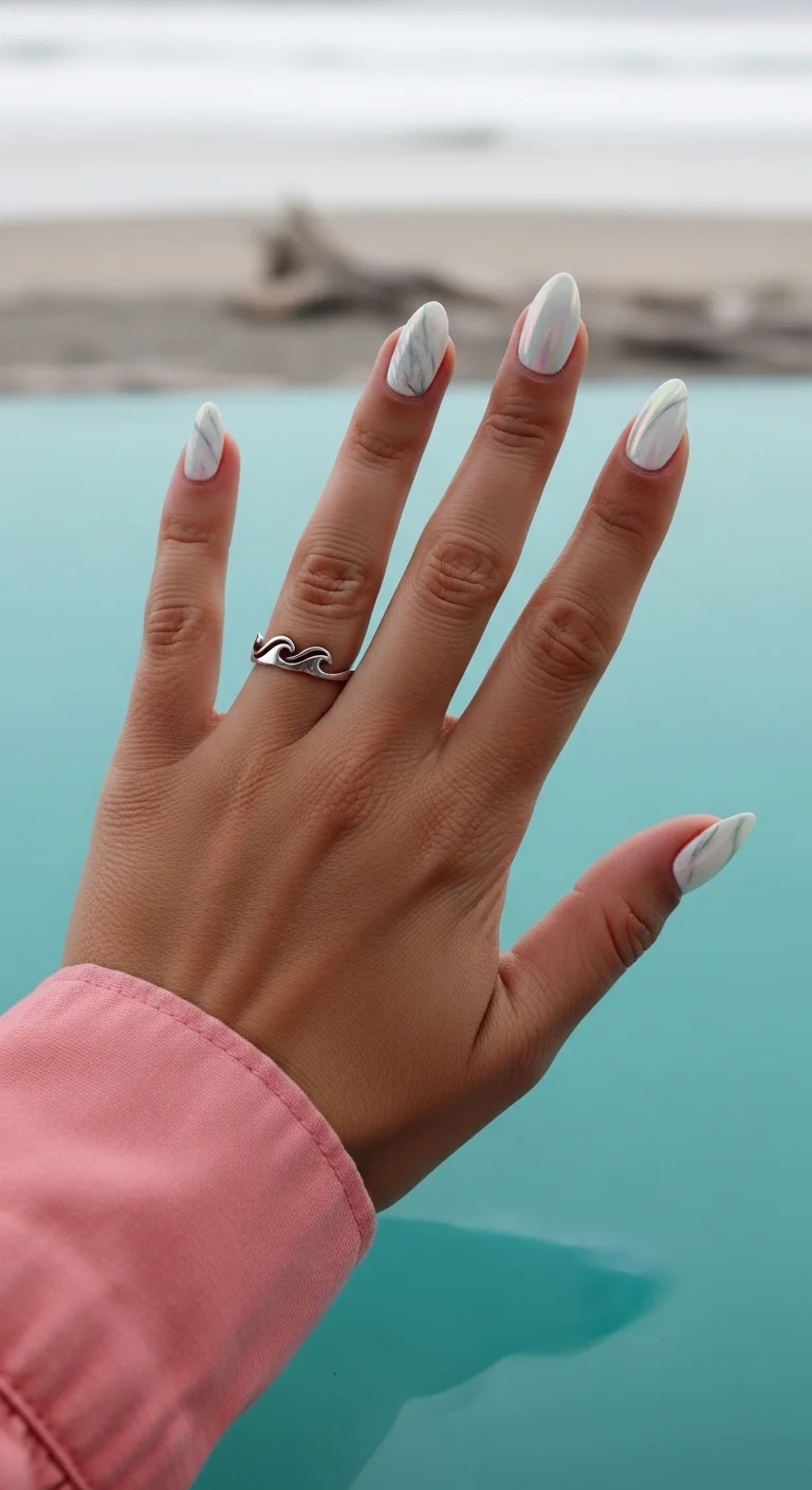 Pearly white nails with green marble and iridescent finish