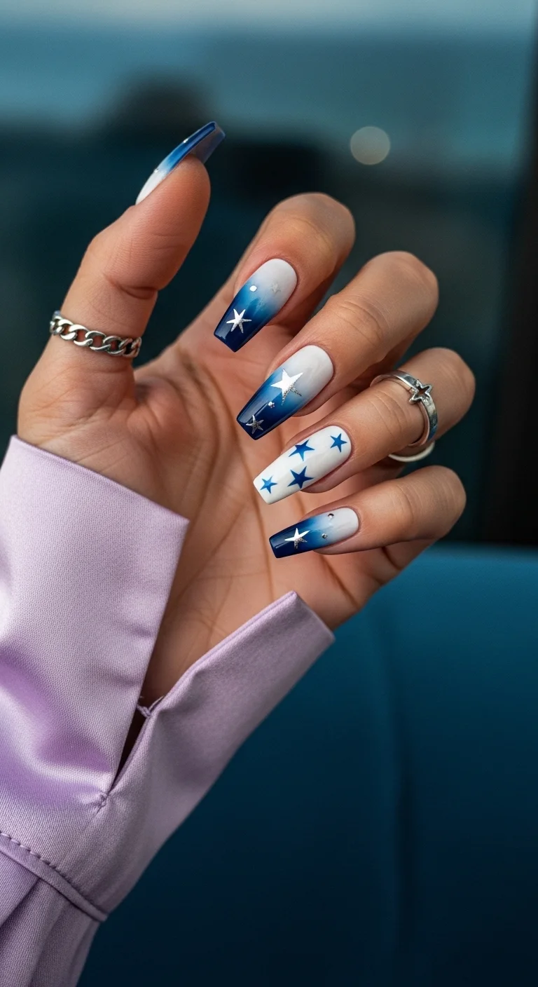 Deep blue to white ombre nails with silver stars