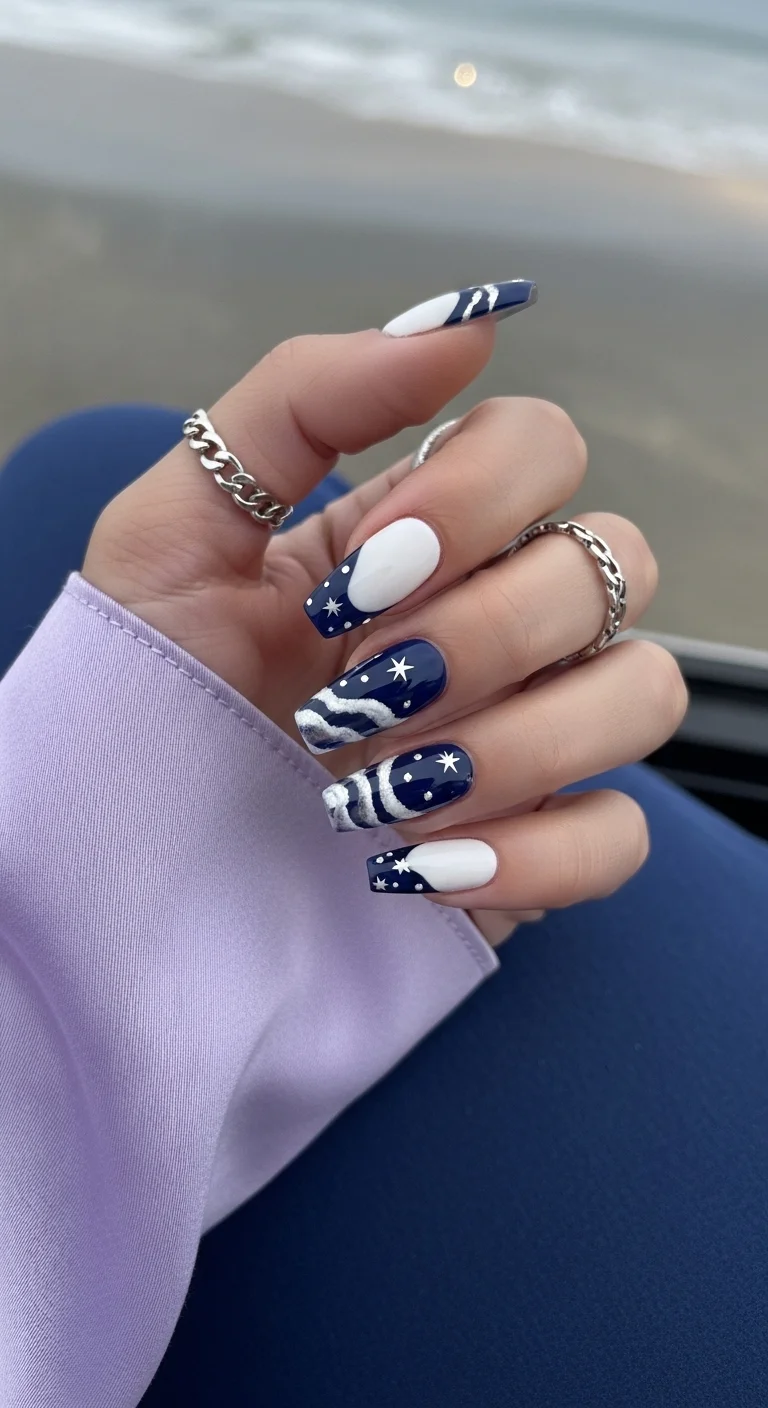 Navy blue and white nails with silver stars and foam art