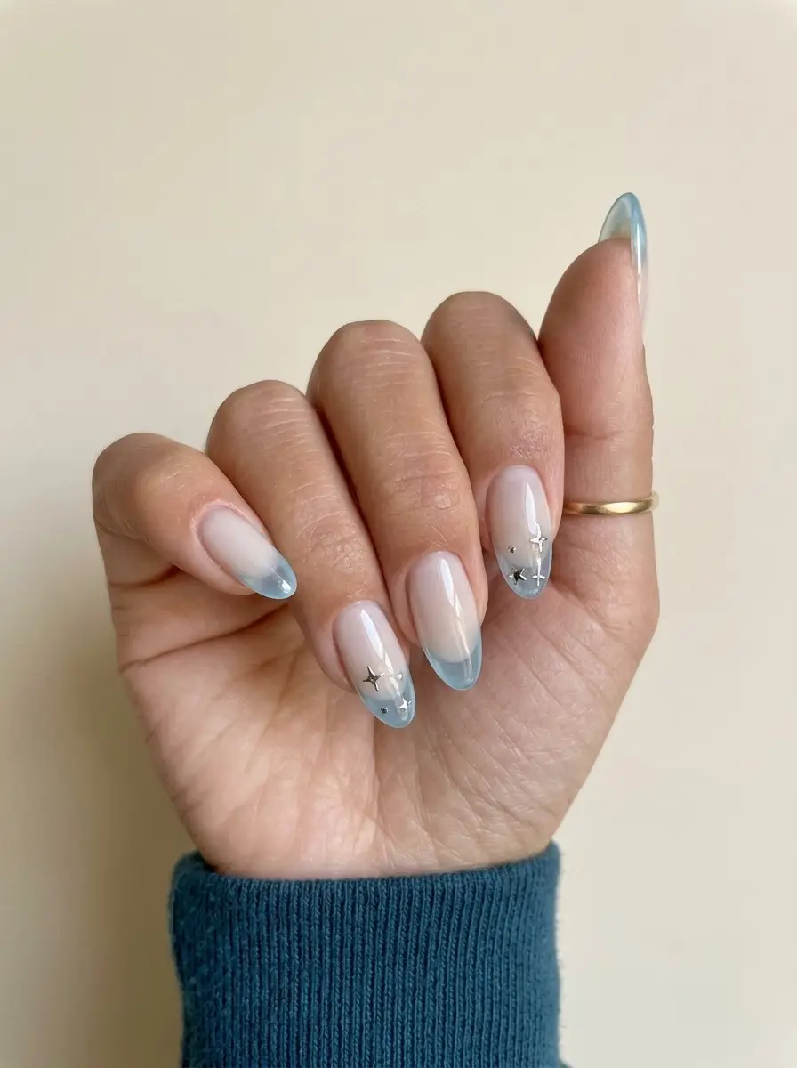 Icy Blue French Nails With Silver Stars - Sheer nude base with pale icy-blue French tips and silver stars