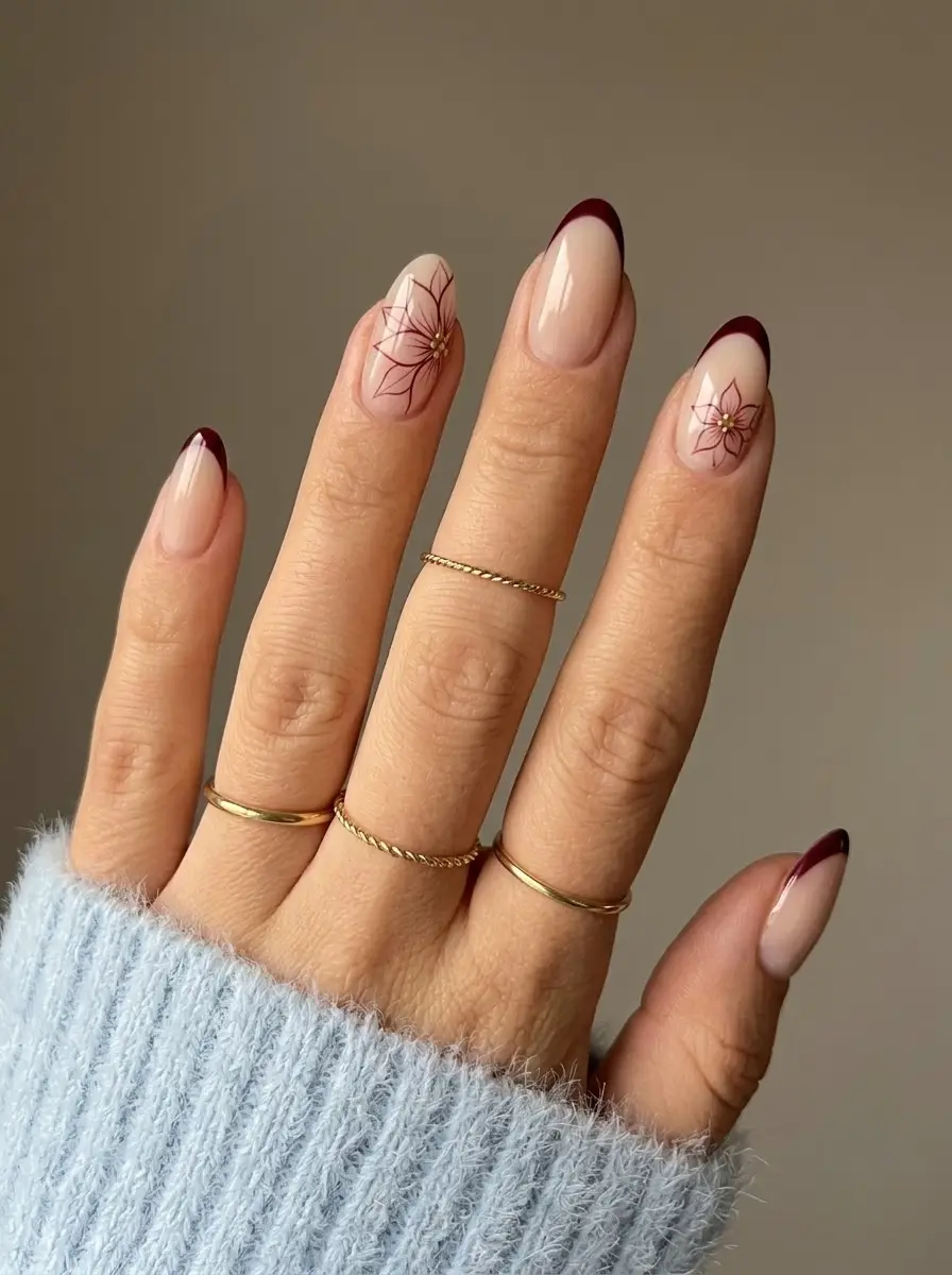 Burgundy French Poinsettia Christmas Nails - Sheer nude nails with burgundy French tips and poinsettia floral artwork