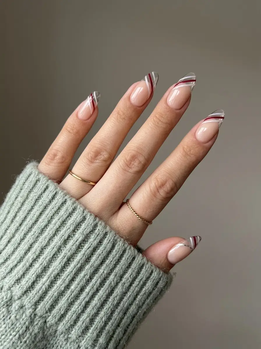 Burgundy and Silver Striped French Christmas Nails - Sheer nude base with diagonal burgundy and silver French lines