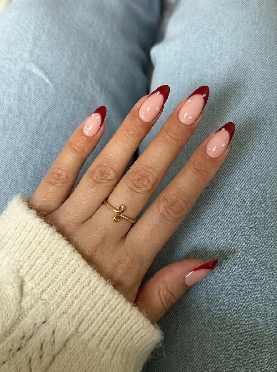 Minimal Burgundy French Christmas Nails - Glossy translucent blush short almond nails with deep wine-red French tips and subtle dot accents