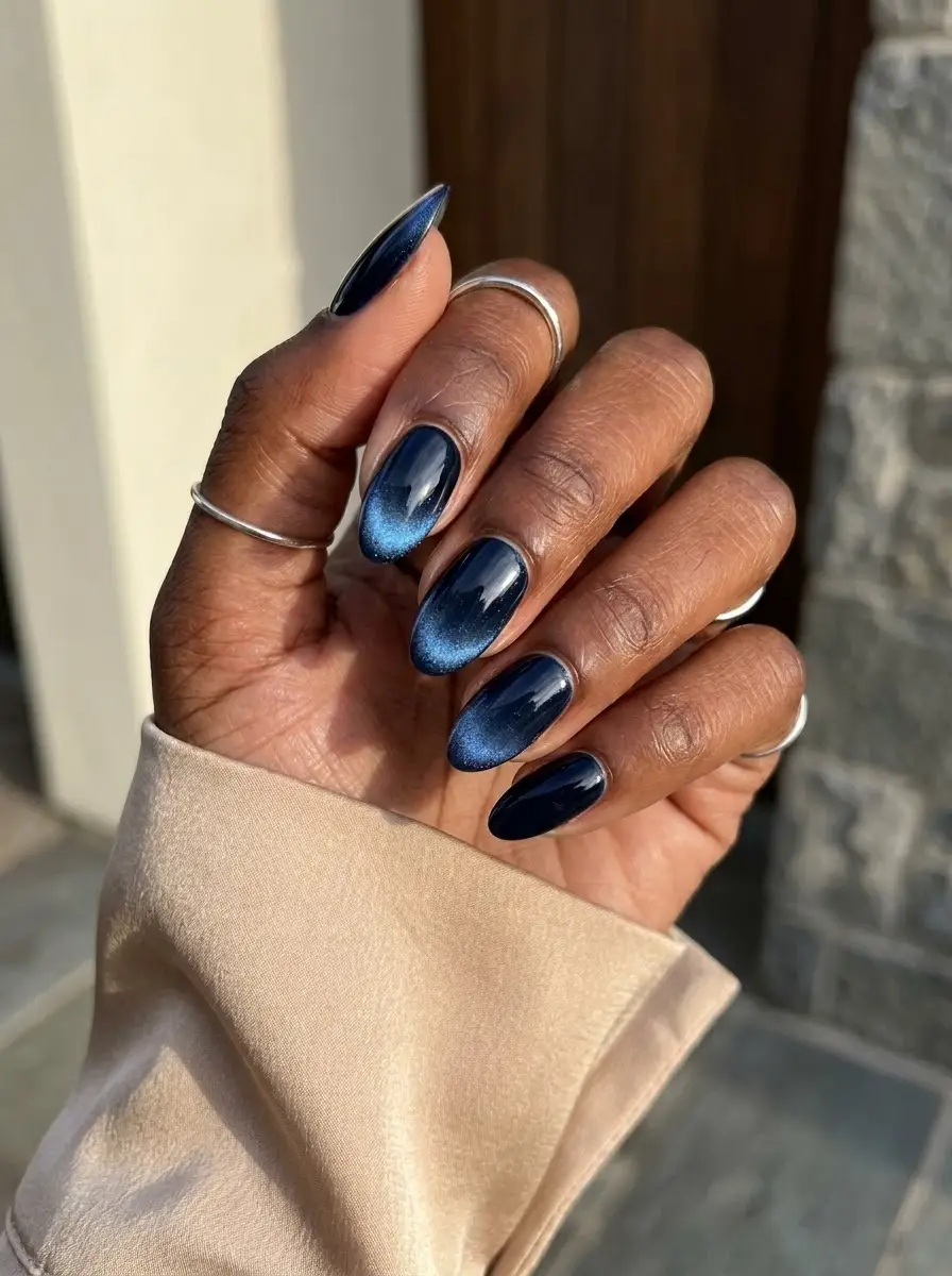 Midnight Blue Magnetic Cat-Eye Nails - Deep midnight navy almond nails glowing with a central magnetic blue cat-eye shimmer band