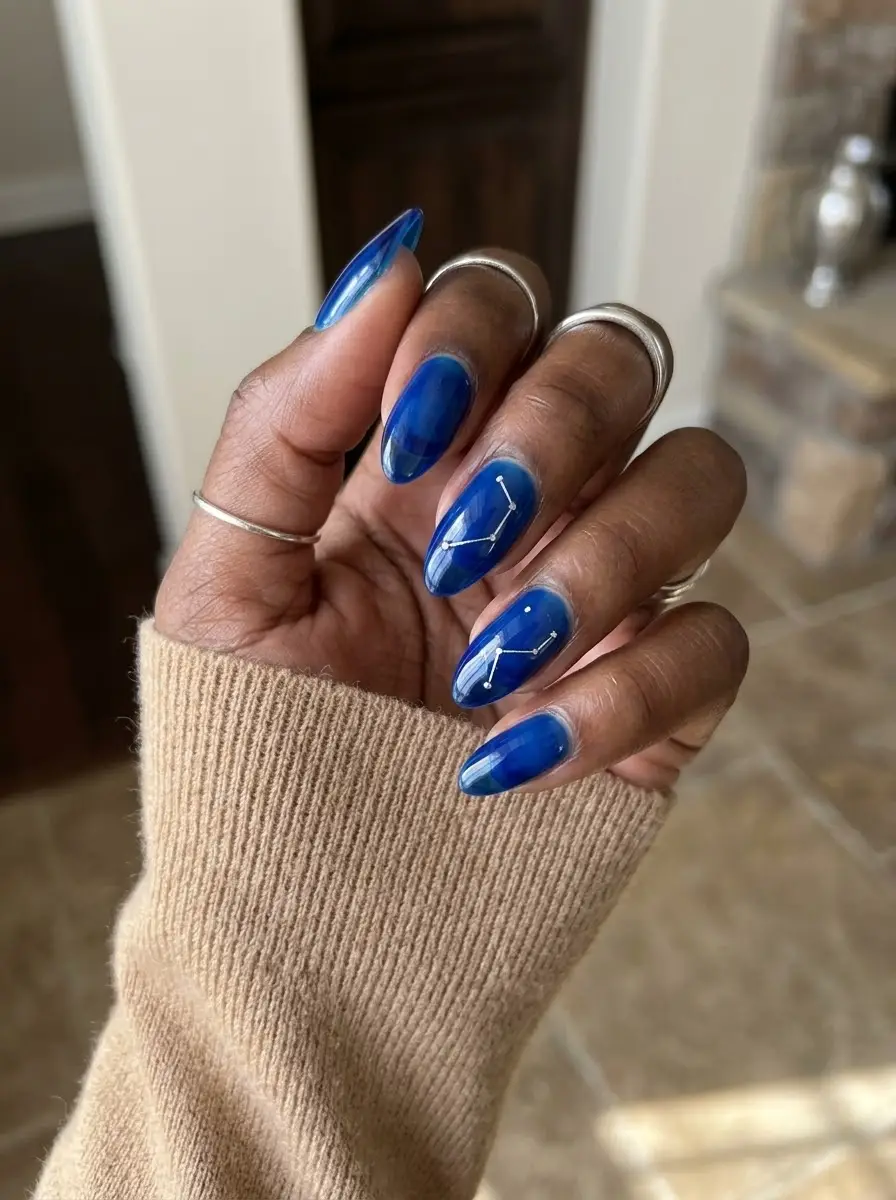 Cobalt Blue Constellation Nails - Bold glossy cobalt blue base styled with delicate white star-map constellation lines and dots