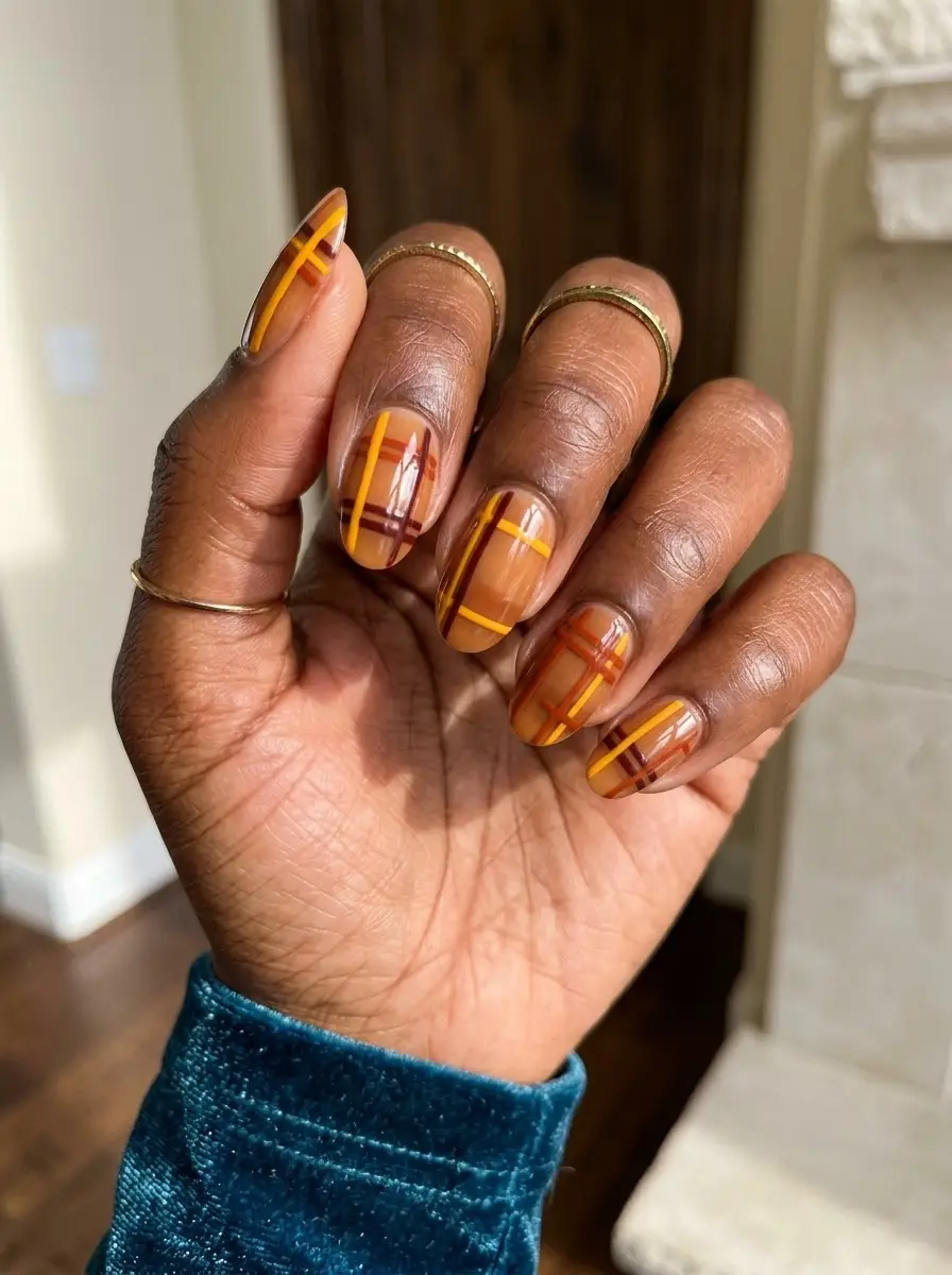 Warm Caramel Plaid Nails - Translucent caramel base with fine plaid lines in mustard yellow, burnt orange, and deep brown