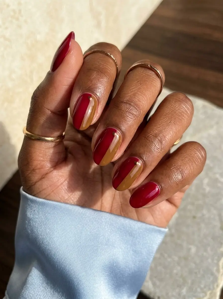 Deep Red & Amber Split-Color Nails - Glossy deep crimson nails paired with vertical split red and honey-amber accent nails