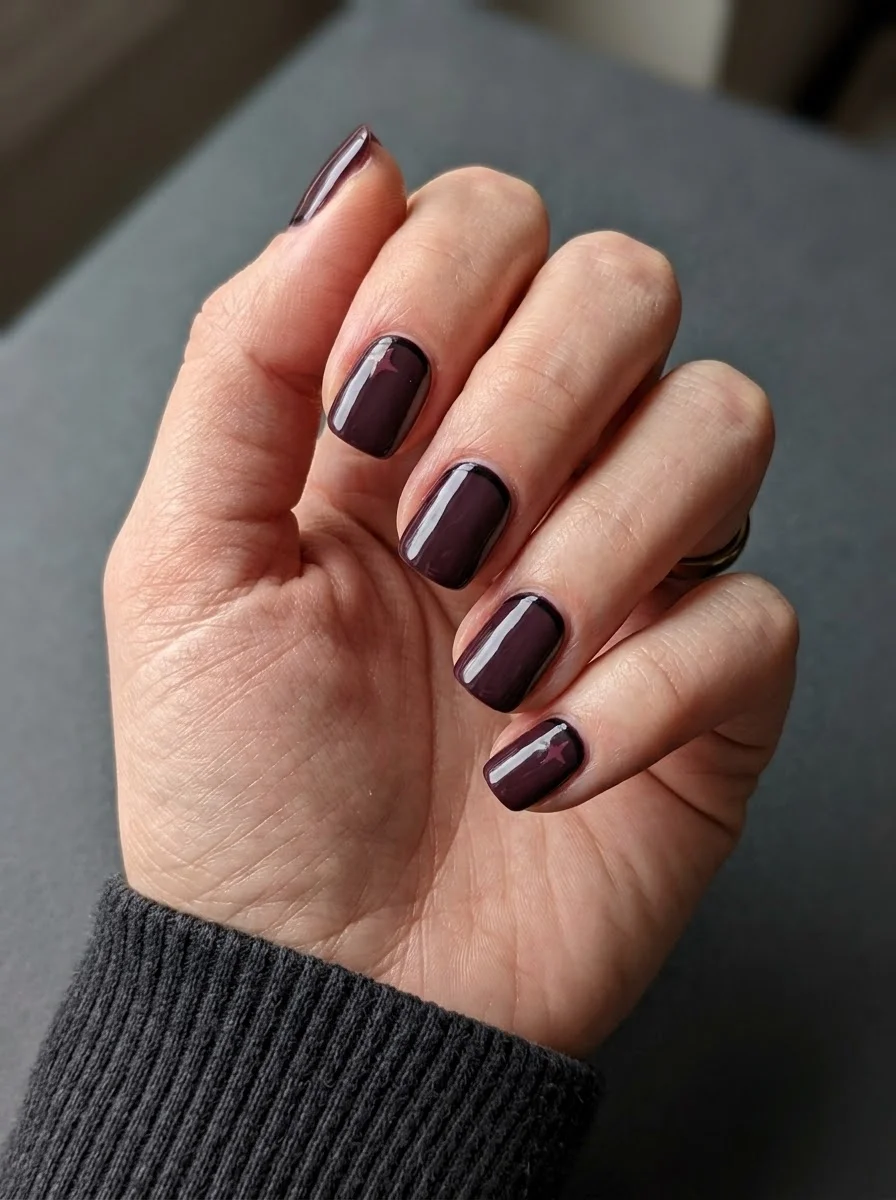 Deep burgundy nails with star accent