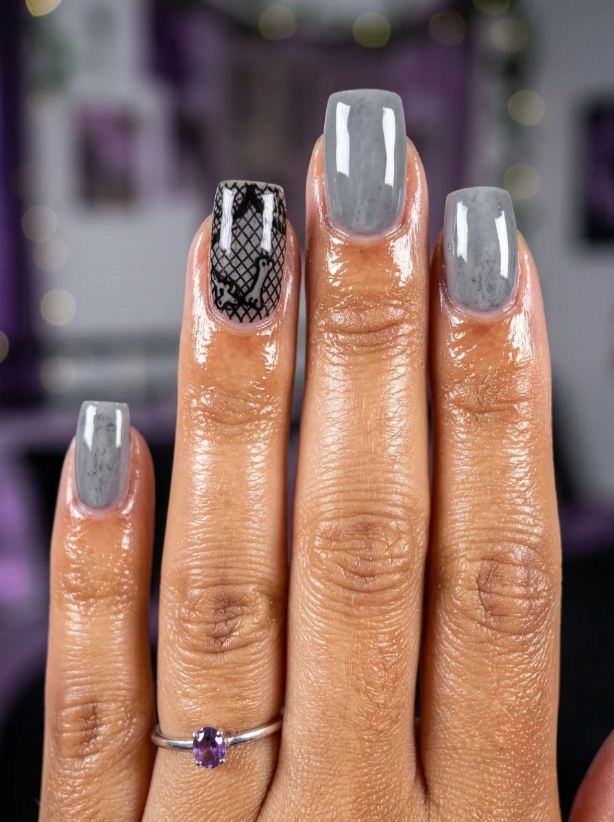 Light grey coffin nails with a marble texture and a black lace accent nail.