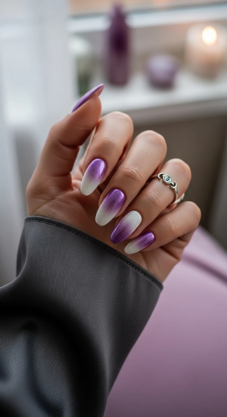 Almond nails with a metallic purple shimmer at the cuticle fading to white at the tips.