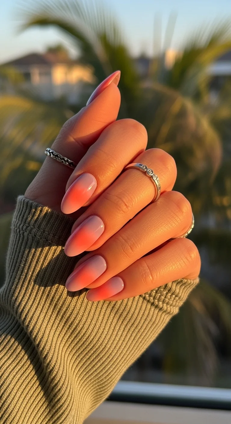 Nude nails with a soft orange and pink 'aura' center.