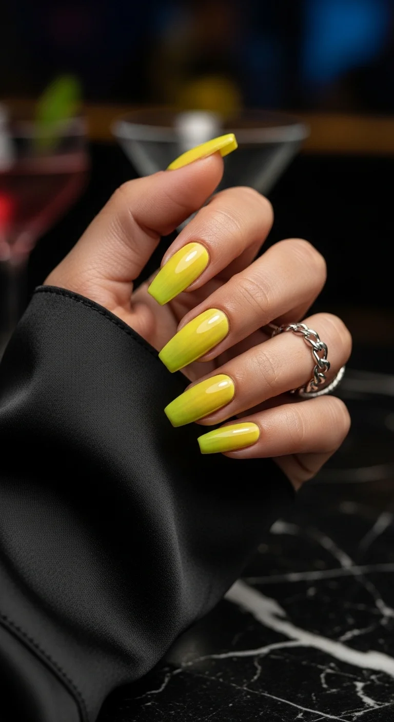 Coffin nails with a seamless gradient from a milky base to a blindingly bright neon yellow.