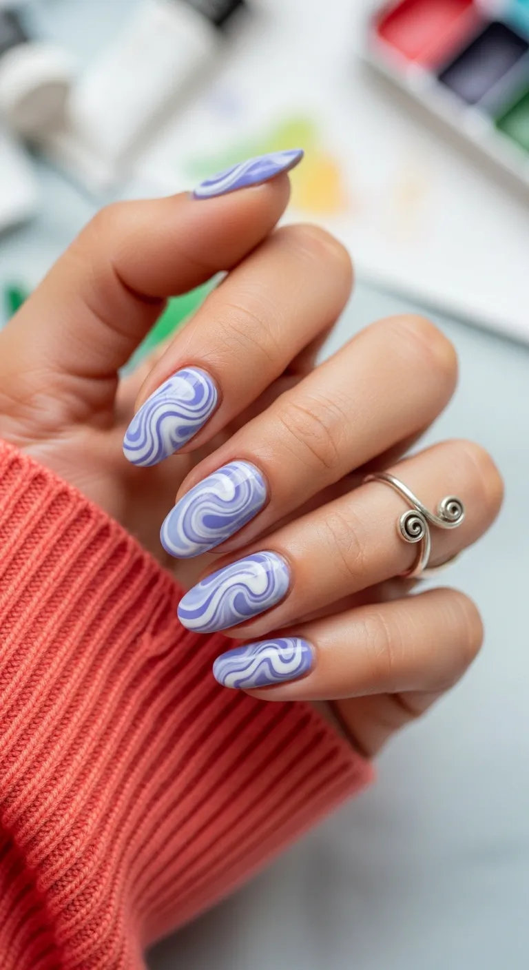 Long oval nails with purple and white swirls