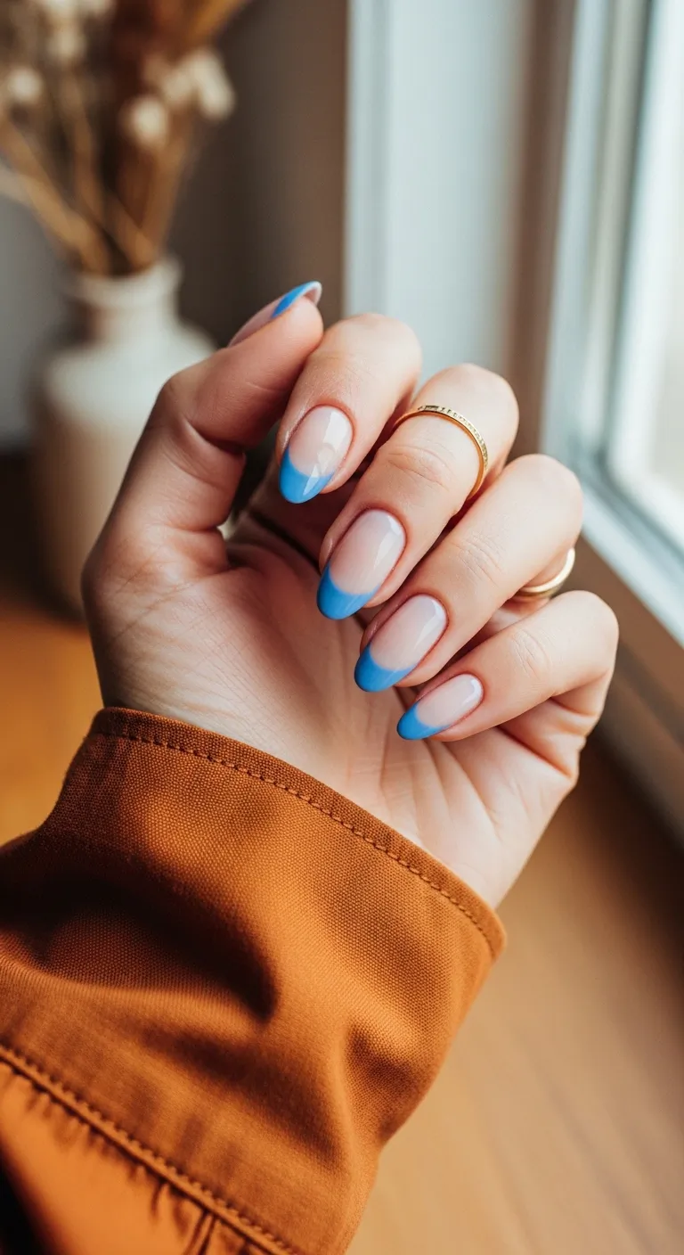Nude nails with bright blue French tips