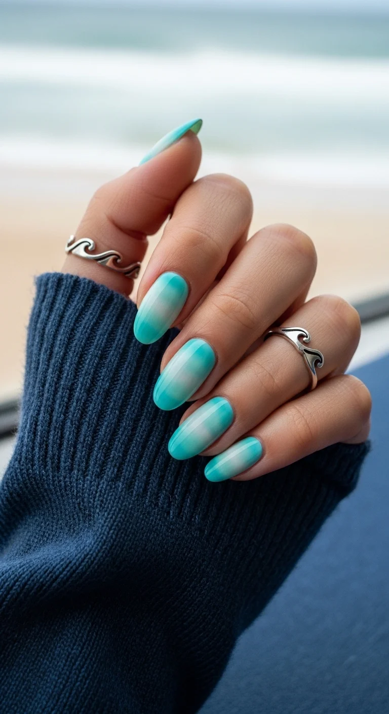 Almond nails with a vertical ombre gradient from white to deep mint-teal.