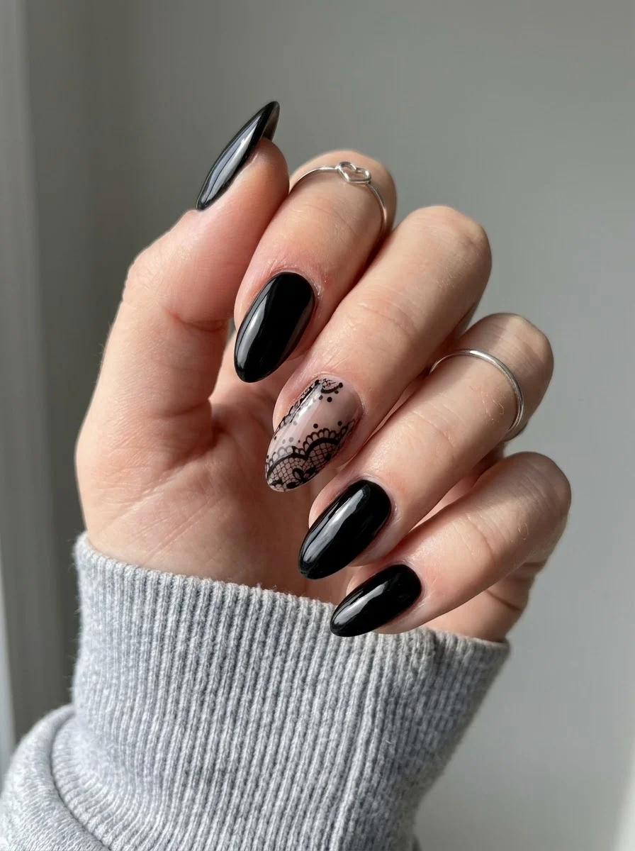 Black Lace Accent - Solid black nails with an intricate lace pattern on the ring finger