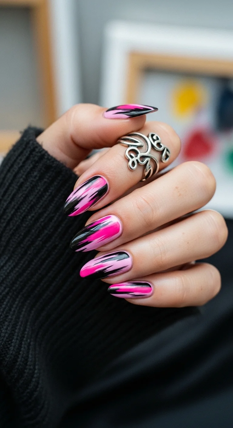 Light pink almond nails with black and hot pink 'lightning' or jagged abstract strokes.