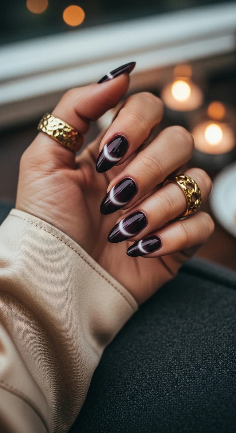 Deep plum cat eye nails with white crescent moon shapes